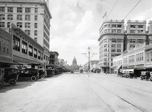 Photograph of Congress Avenue looking north showing automobiles and the streetcar line