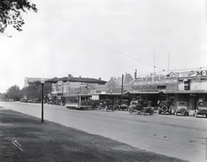 Photograph showing a streetcar and automobiles along Guadalupe Street