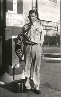 Photograph of man dressed as a service station attendant